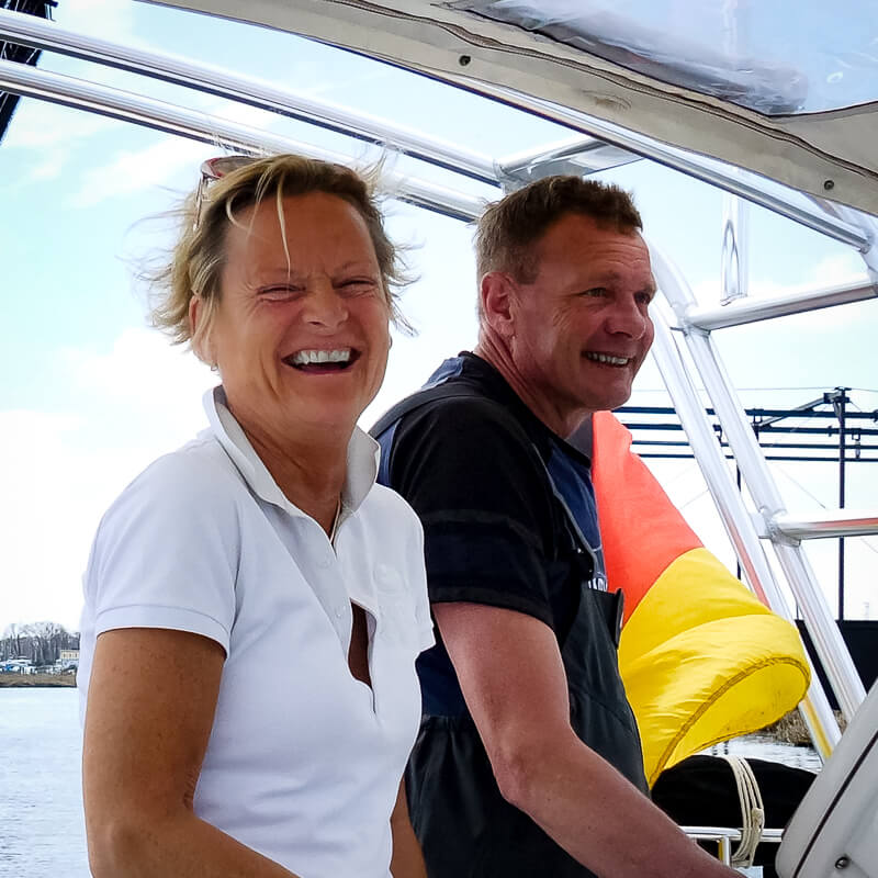 Tessa and Hartmut Ludwig, a happy sailing couple, smiling and enjoying their time on a boat during a sailing trip